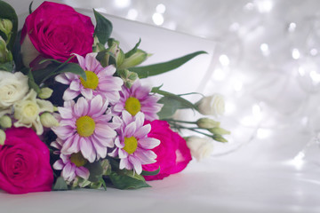 Floral festive background template. A bouquet of flowers on a light background bokeh.