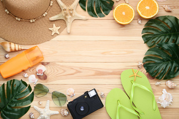 Summer accessories with seashells on brown wooden table