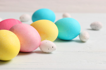  Easter composition of painted eggs and feathers on wooden background. Background for Easter, a place to insert text