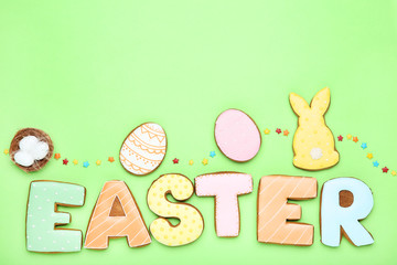 Word Easter by gingerbread cookies with sprinkles on green background
