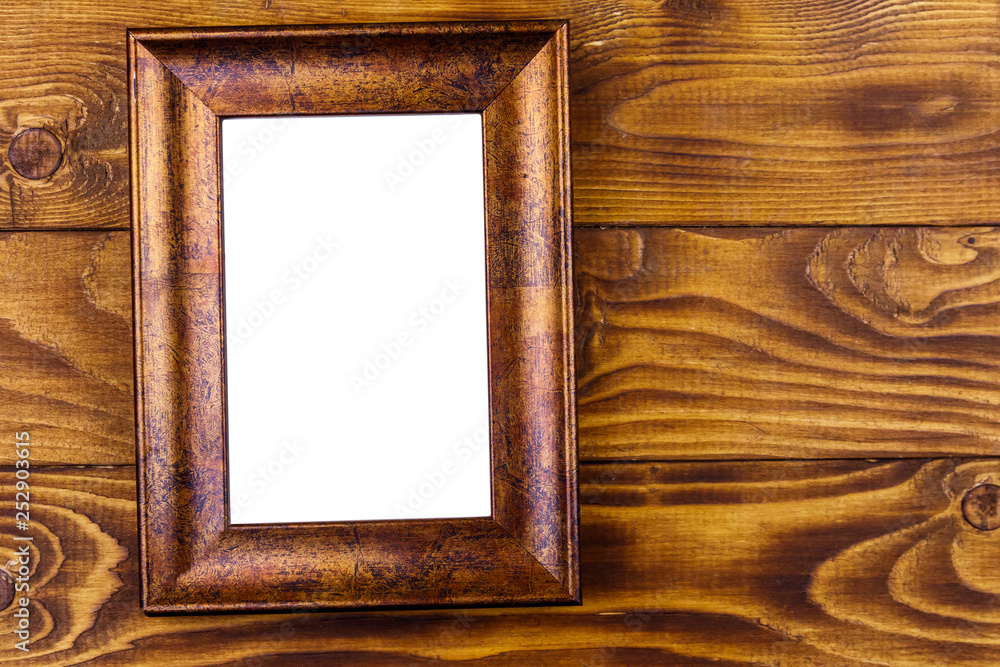 Wall mural empty photo frame on wooden background. top view