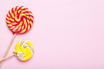Colorful lollipops on pink background
