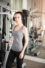 Pretty young sport woman is drinking water  in gym, Healthy lifestyle