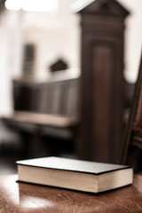 Songbook lies on the old bench in the church