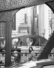 young lady crossing the bridge while exploring chicago