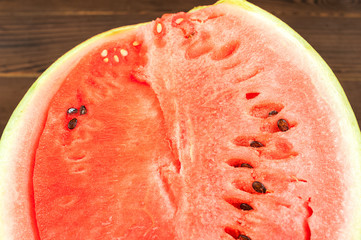 Watermelon with seeds, cut in half close up and copy space. A large ripe watermelon on the...