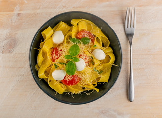 Yellow italian pasta pappardelle, fettuccine or tagliatelle