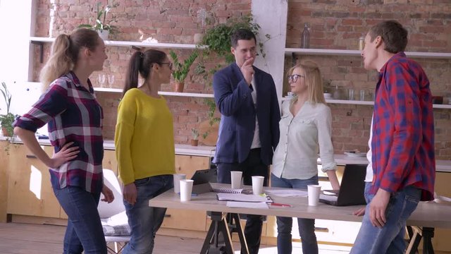 portrait of successful businesspeople in modern office, Creative team men and women communication at work during break in kitchen standing at table