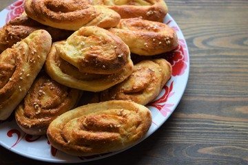 Fresh salt cake with cheese and garlic on a wooden table