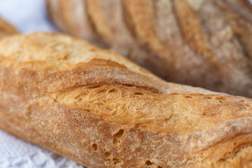 Closeup fresh baked bread on light blurred background