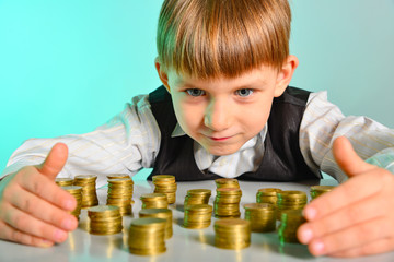 A cute baby is hugging his money coins