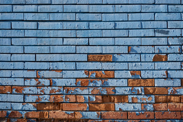 Old blue brick wall with flaking paint
