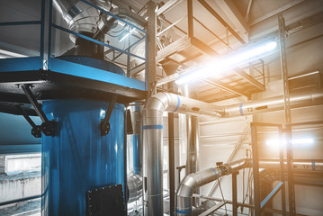 condensing economizer with fuel supply system pipes for solid-state chip boiler. Blue toning with lamps flare