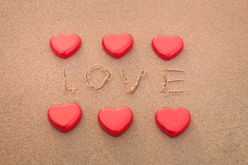 Chocolate color Lovely red heart on the beach. Background is a natural in real place, creative Valentine's Day Concept, tropical style background made in Phuket, Thailand.
