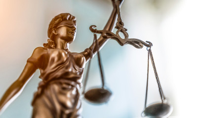Statue of lady justice on bright background - Side view with copy space.