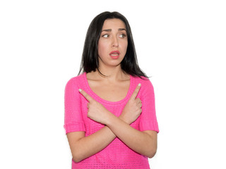 Portrait of attractive girl pointing with crossed hands in diffe