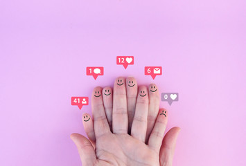 happy and sad fingers with notification icons.  social network concept