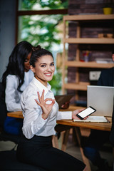 Female Office Worker Showing Ok in Office