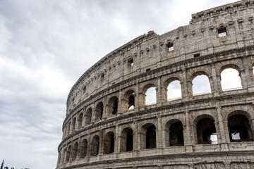 Fototapeta na wymiar Facade of the Great Roman Colosseum (Coliseum, Colosseo), also known as the Flavian Amphitheatre. Famous world landmark. Scenic urban landscape.