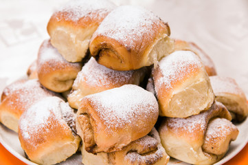 a stack of buns on a white plate