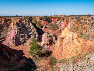 abandoned bauxite quarry in the land of Murgia with blue sky. Alta Murgia National Park, Apulia,...