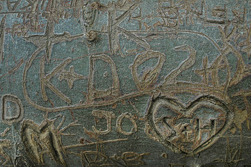 Names and hearts etched in tree bark, love sworn