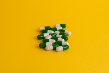pills in yellow background