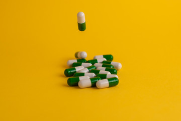 pills in yellow background
