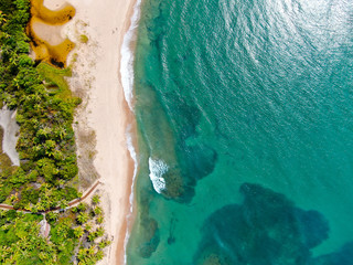 Aerial top of river tropical merging to white sand beach and turquoise clear sea water with small...