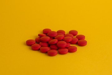 pills in yellow background