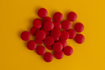 pills in yellow background