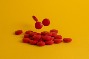 pills in yellow background