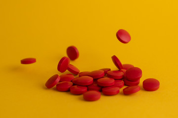 pills in yellow background