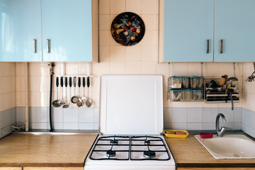 Simple kitchen interior with shabby wall cabinets in old house