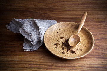 Fasting, Lent. Plate with spoon and crumb on wooden background