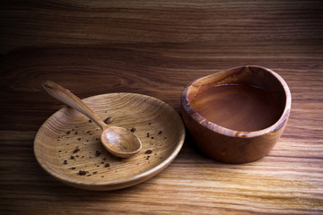 Fasting, Lent. Plate with spoon and cup of water on wooden background