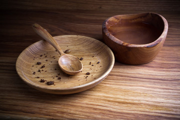 Fasting, Lent. Plate with spoon and cup of water on wooden background