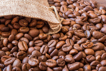 A coffee bean background that pour out of a linen bag_