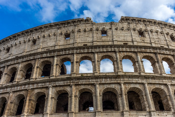 Fototapeta premium Facade of the Great Roman Colosseum (Coliseum, Colosseo), also known as the Flavian Amphitheatre. Famous world landmark. Scenic urban landscape.