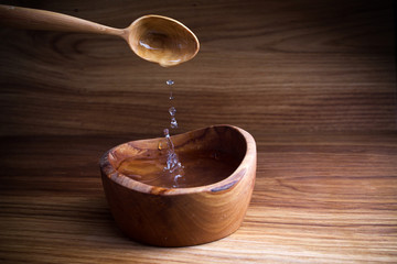 Fasting, Lent. Spoon and cup of water on wooden background