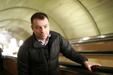 Man moves on escalator in subway