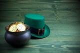 Happy St Patricks Day leprechaun hat with gold coins on vintage style green wood