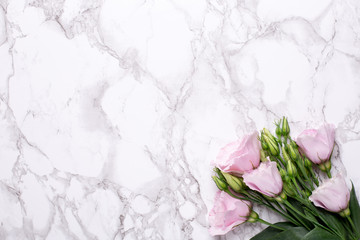 Romantic background with pink flowers on marble table
