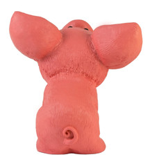 Toy pig is sitting with its tail turned. White background