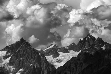 High mountains with glacier and cloudy sky at summer day