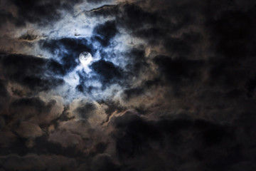 Fototapeta na wymiar Beautiful night sky with full moon. Dramatic clouds in the moonlight from full moon