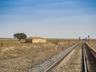Fototapeta na wymiar Rural landscape of a railway track and a small railway station