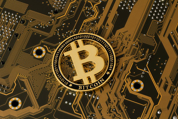 Gold coin, computer circuit board with bitcoin processor and microchips.