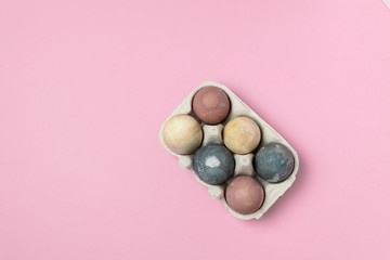 Selective focus of coloured decorated easter eggs in cardboard container