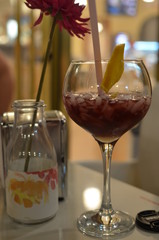 glass of wine and bottle of wine on wooden table